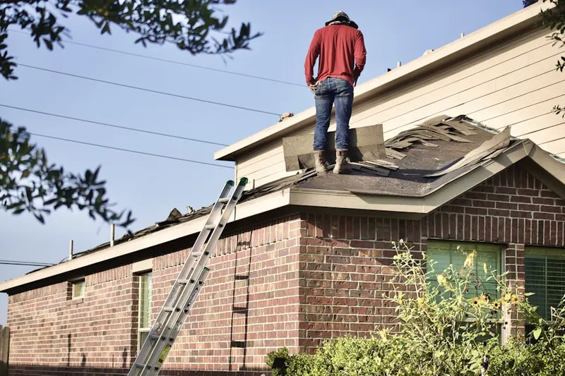 Professional roofer working on a residential roof in Dearborn